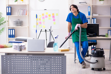 Male handsome professional cleaner working in the office 