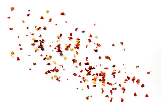 Chilli Flakes Scattered over White Background Top View