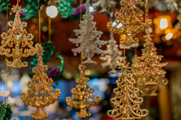 Fototapeta premium Christmas decorations displayed for sale at a Christmas Market at in Munich, Germany. Decoration products hanging at street stall.