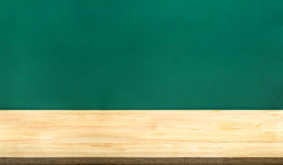Empty wood table and green blackboard at background.education school concept product display template.Business presentation..