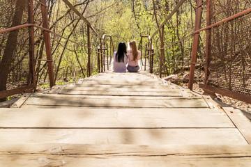 two women are sitting on the steps