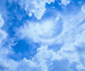 Beautiful Sun circle aura good weather in blue sky and white clouds background
