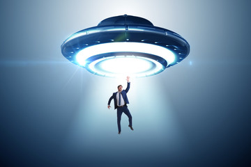 Flying saucer abducting young businessman 