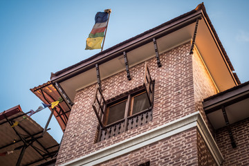 Fototapeta na wymiar Colorful Buddhist flags on a roof