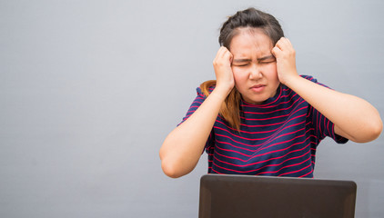 Young women are stressed and sitting on the floor with computer,Business concept 