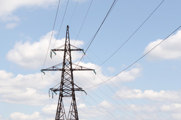 High voltage tower in blue sky background