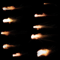 Texture of firearm shot with bright flash of light, sparks, smoke and gunpowder gases on black background