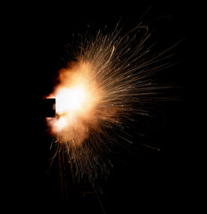 Texture of firearm shot with bright flash of light, sparks, smoke and gunpowder gases on black...