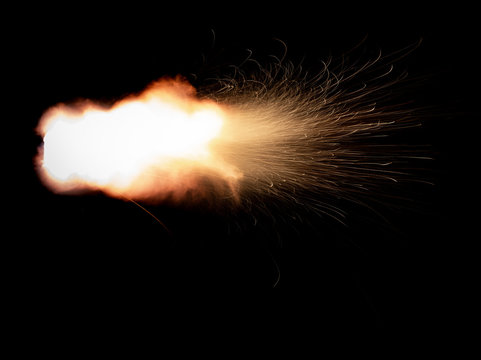 Texture of firearm shot with bright flash of light, sparks, smoke and gunpowder gases on black background