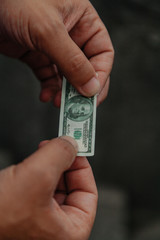 Miniature bill in hands of  man