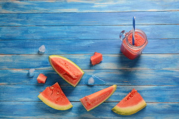 Fresh watermelon cocktail in glass on a blue wooden rustic background, copy space. Freshly blended summer watermelon smoothie