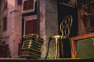 Vintage accordion next to a fancy metal chair