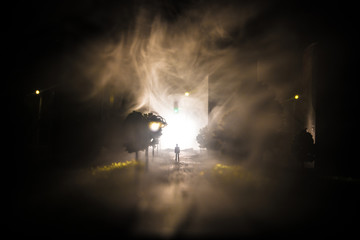 Artwork decoration. A man standing on a road of burnt up city. Apocalyptic view of city downtown as...
