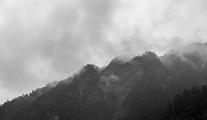 clouds over the mountains in black and white