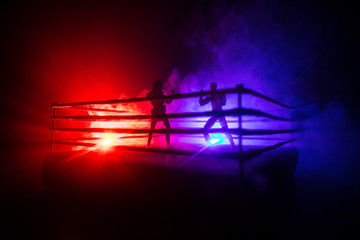 Man and woman boxing on the ring. Sport concept. Artwork decoration with foggy toned dark...