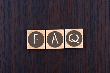 FAQ message on wooden letters. Frequently Asked Questions