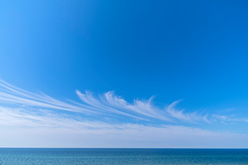 Blue sky cirrus clouds sea panorama.