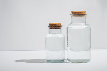glass bottles with cork lids on a white background, side view