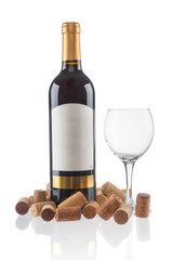Red wine bottle with empty glass and corks on white background