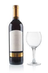 Red wine bottle with empty glass on white background
