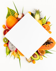 Still life with fresh assorted exotic fruits on a palm leaf.
