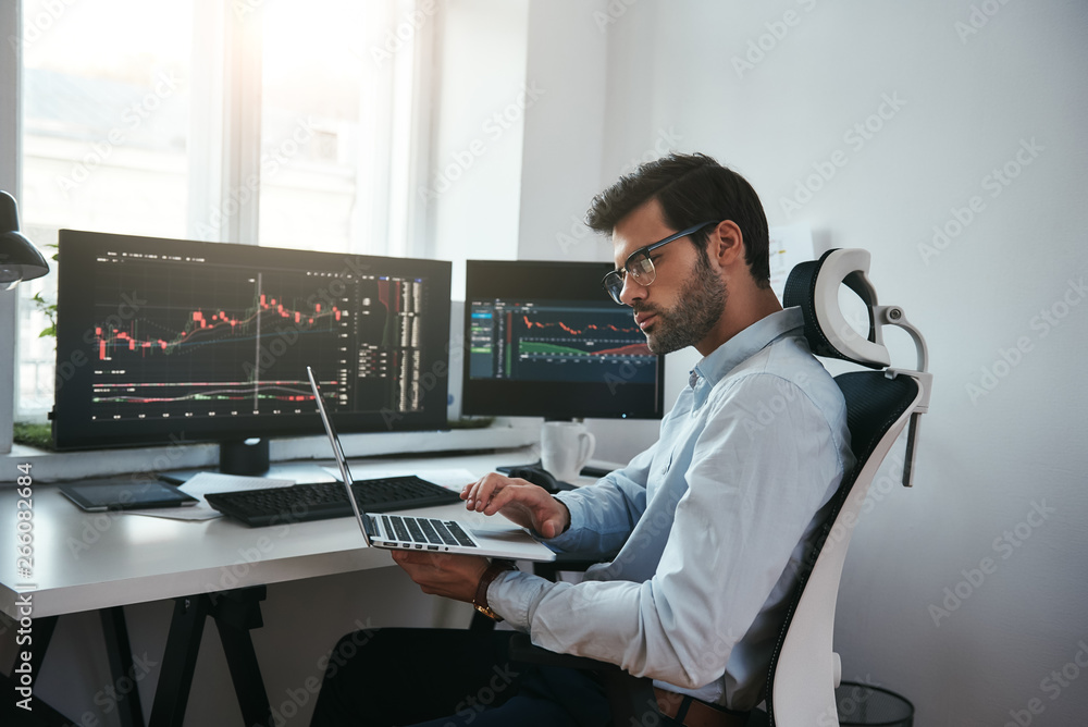 Aufkleber business information. bearded trader wearing eyeglasses analyzing financial market via laptop while 