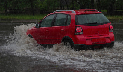 car rides in heavy rain on a flooded road
