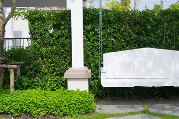 outdoor wooden swing in the green garden