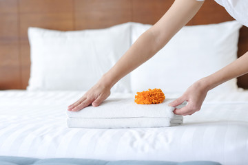 Obraz na płótnie Canvas Hands of hotel maid bringing fresh towels to the hotel room