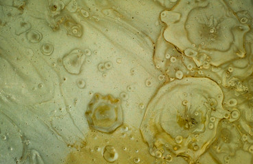 close up view of the prismatic mud volcano river with air bubbles