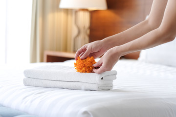 Hands of hotel maid bringing fresh towels to the hotel room