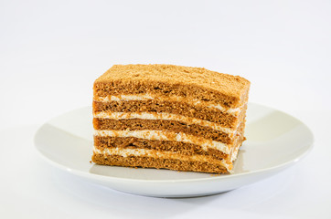 piece of cake in a plate on a white background