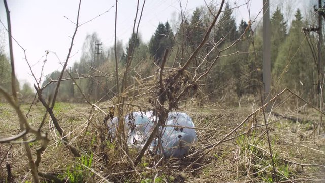Trush bag lying in the forest. Social irresponsibility. Save the nature concept. Crane shot