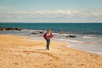Nine year old boy runs along the seashore