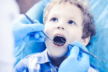 Doctor and patient child. Boy having his teeth examined with dentist. Medicine, health care and stomatology concept