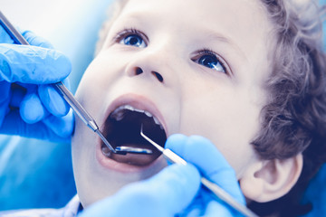 Doctor and patient child. Boy having his teeth examined with dentist. Medicine, health care and stomatology concept