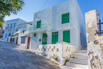 Fototapeta na wymiar Street view of Plaka picturesque village with paved alleys and traditional houses in Milos island in Cyclades, Greece
