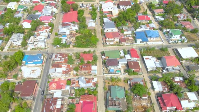 Aerial, flight over the city of Paoay in the Philippines, showing the urban area with some structures with interesting details