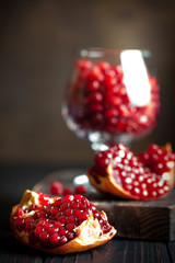 Ripe pomegranate fruit on a old black wooden vintage background. Selective focus.