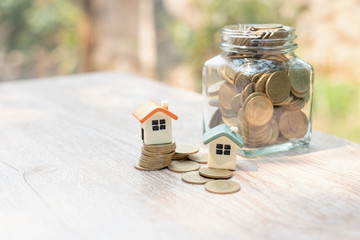 Business Startup. mortgage and real estate investment. mini house on coin stack