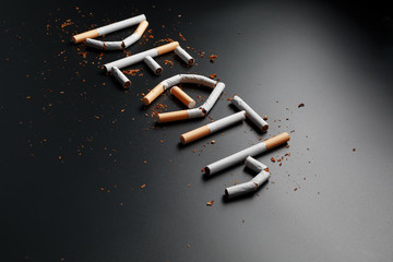 The inscription DEATH from cigarettes on a black background. Stop smoking. The concept of smoking kills. Motivation inscription to quit smoking, unhealthy habit.