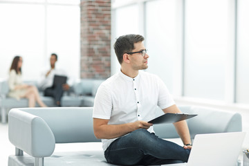 close up.young businessman sitting in the lobby of the business center