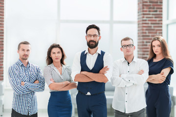 confident business team standing in a modern office