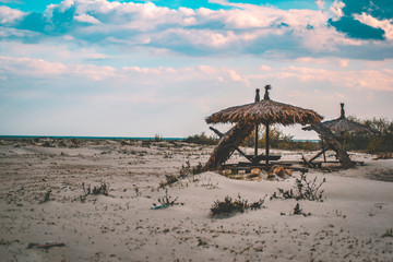 Fototapeta na wymiar Beach Umbrellas on an empty beach melancholia concept romantic landscape empty beach travel concept