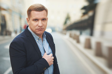 Serious man in suit on the street