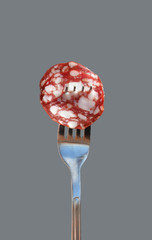 slice of sausage on a fork