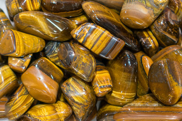 Tiger Eye Stones Ready to Make Handmade Jewelry. tiger's eye and hawk's eye gemstone as natural mineral rock specimen