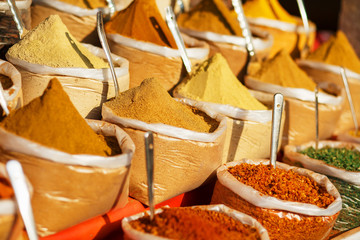 Colorful spices in bags at a market in Goa