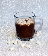 hot delicious coffee with sweet marshmallow air on silver background.