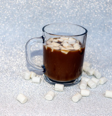 hot delicious coffee with sweet marshmallow air on silver background.
